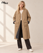 Model wearing the khaki Empress Quilted Long Coat; Moussewear logo