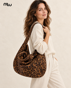Female model showcasing the Wildcat Leopard Slouch Bag with Moussewear logo