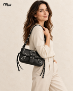Female model showcasing the Riot Studded Shoulder Bag with Moussewear logo