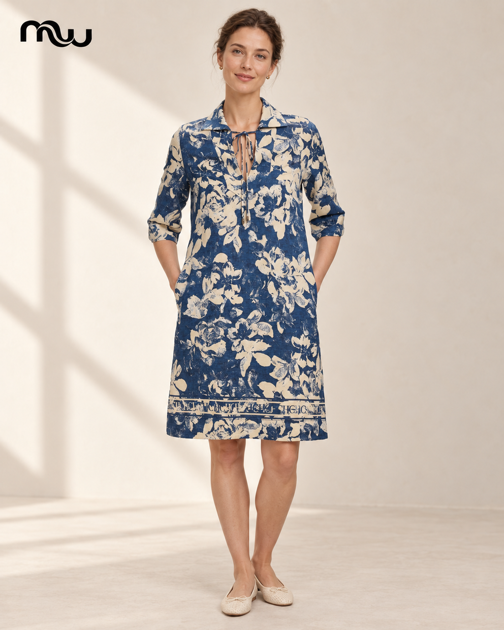 Model wearing the Pillow Talk Floral Tie-Neck Dress with Moussewear logo